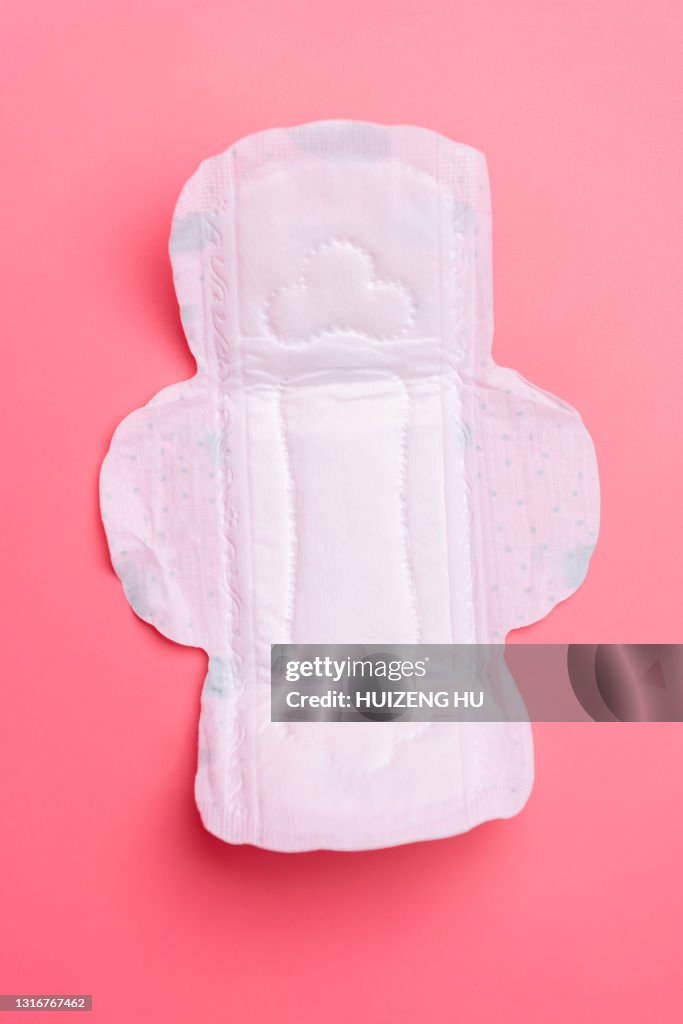 Close up of woman's sanitary pad on pink
