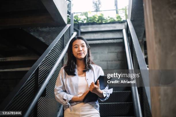 portrait of young professional woman - indonesian faces stock pictures, royalty-free photos & images