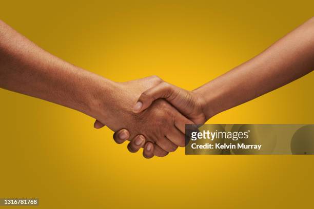 close up of holding hands - handshake stock-fotos und bilder