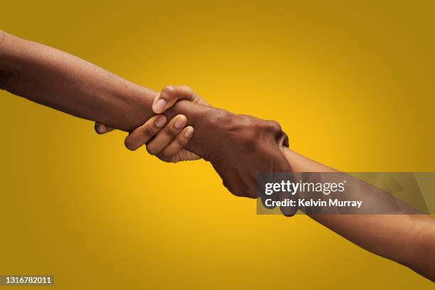 close up of holding hands - trust stockfoto's en -beelden