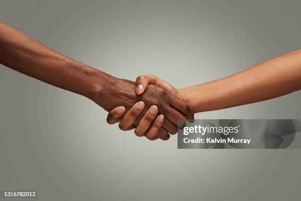 close up of holding hands - handshake close up stock-fotos und bilder