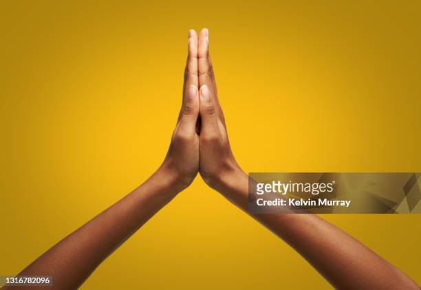 hands clasped together - praying stockfoto's en -beelden