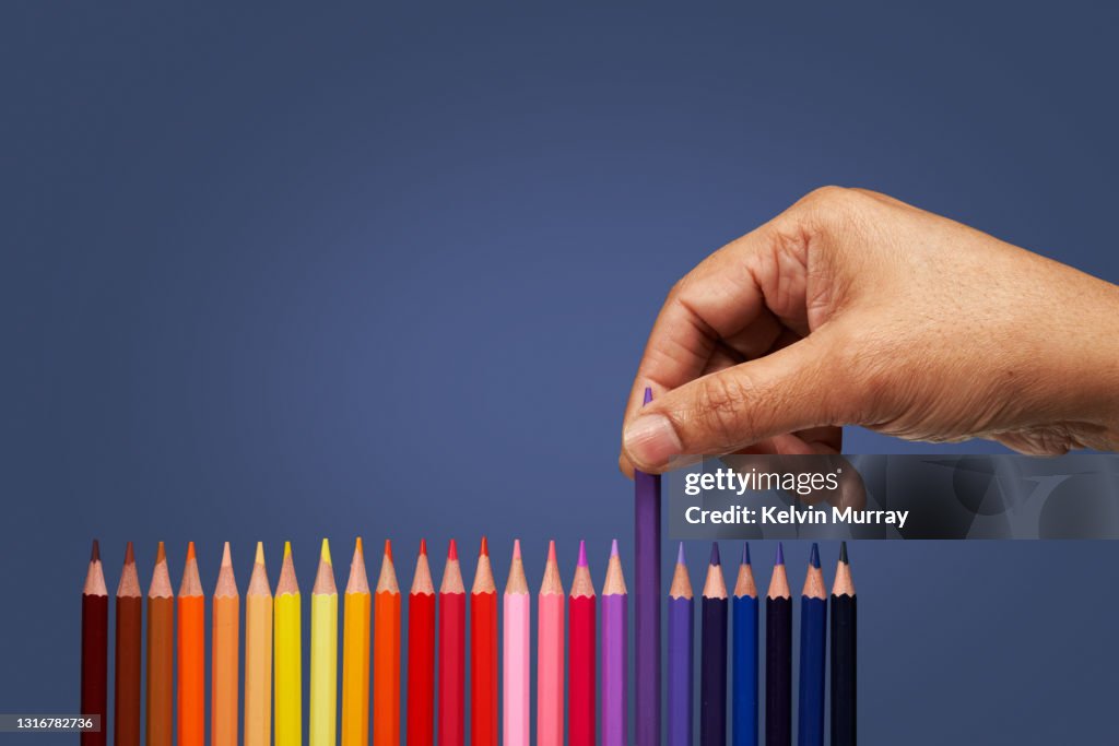 Hand picking coloured pencil