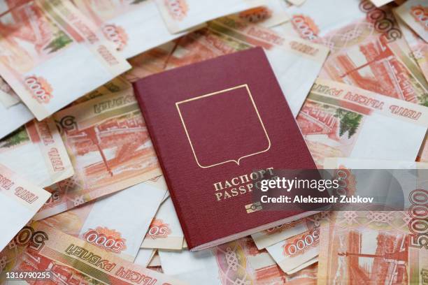 cash five thousand russian rubles in bills, on a white background or table. a bundle of banknotes, a russian passport. the concept of travel and vacation abroad. purchase of a ticket for an airplane flight. - russian culture stock pictures, royalty-free photos & images