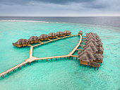 Bongalows over the sea, in an Atoll of the Maldives Islands
