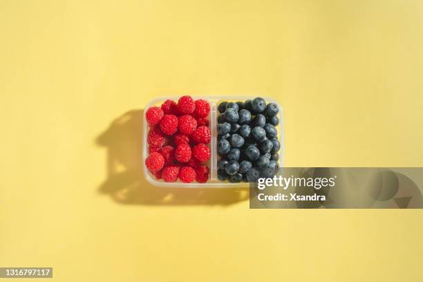 fresh berries in a reusable plastic container - blueberries fruit stock pictures, royalty-free photos & images