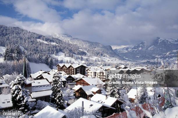 mountain village under snow - gstaad stockfoto's en -beelden