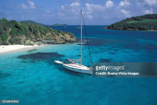 moored sail boat in a blue lagoon - saint martin caribbean foto e immagini stock