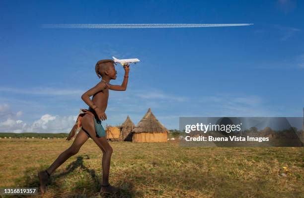 little african girl playing with toy airplane - namibia airplane stock-fotos und bilder