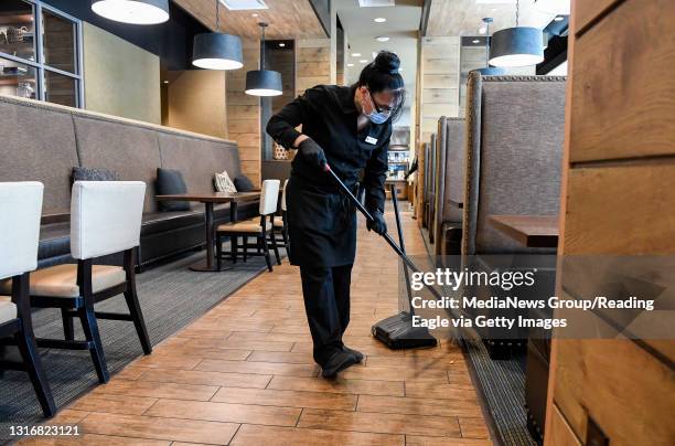 Server Nioka Mantilla sweeps in the restaurant. At the DoubleTree by Hilton Hotel on Penn Street in Reading Friday morning May 7, 2021 where Jim...