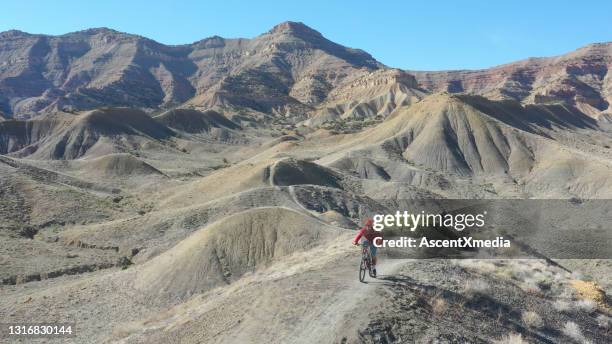aerial view of mountain bikers climbing mountain ridge - fruita colorado stock pictures, royalty-free photos & images