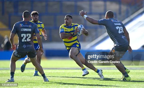 Greg Inglis of Warrington gets past Joel Tomkins and Sam Kasiano of Catalans during the Betfred Challenge Cup quarter final between Catalans Dragons...