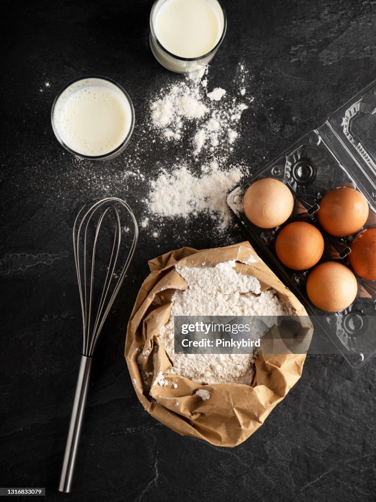 The Process Baking Cake In Kitchen - Dough Recipe Ingredients Eggs, Flour,  Milk, Butter, Sugar On Table From Above. Bake Sweet Cake Dessert Concept.  Top View. Stock Photo, Picture and Royalty Free