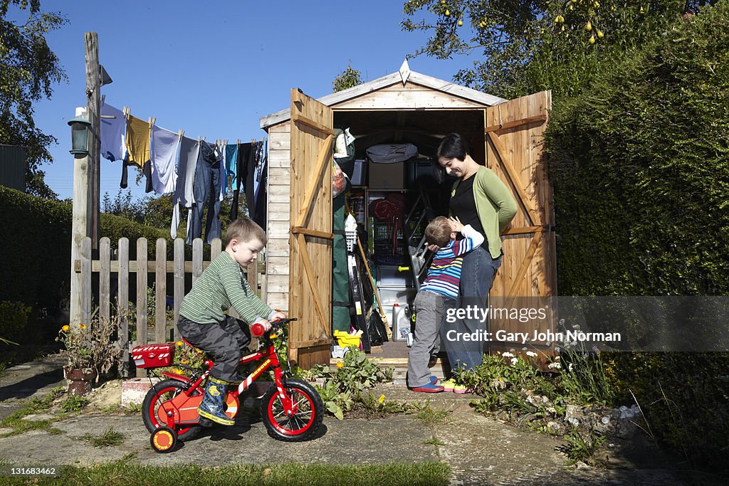 Boys enjoy playing in the garden with mummy close