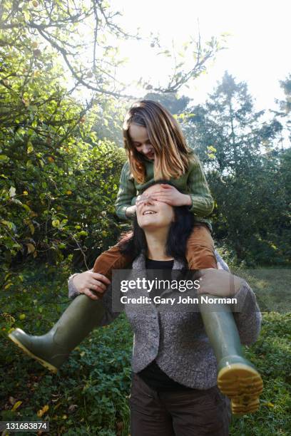 mother daughter play together - augen zuhalten stock-fotos und bilder