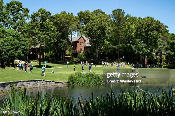 Steve Stricker, Darren Clarke from the Bahamas and Mike Weir from Canada waves putting on the 4th hole during the second round of the Regions...