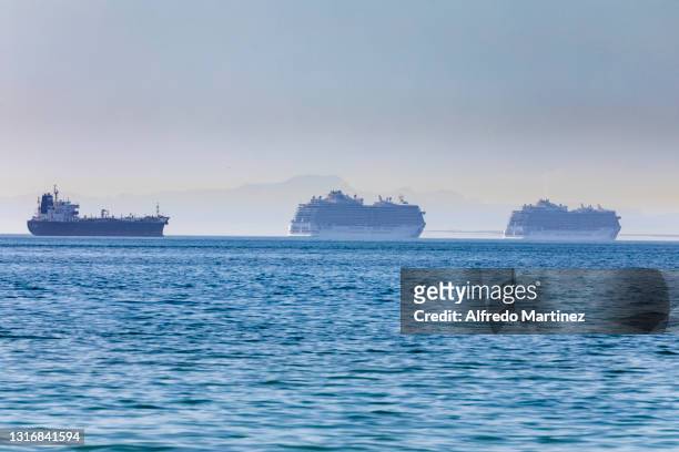 Ship and two Cruises are anchored on the outskirts of the Bay of La Paz, during a protest against cruise ships industry on May 6, 2021 in La Paz,...
