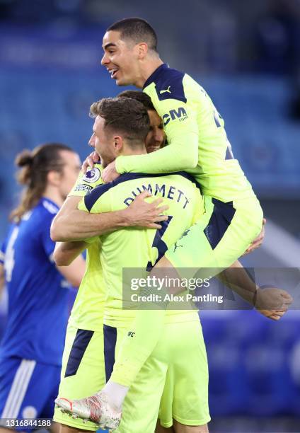 Paul Dummett of Newcastle United celebrates with Miguel Almiron and Federico Fernandez after scoring his team's second goal during the Premier League...