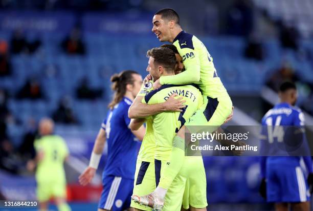 Paul Dummett of Newcastle United celebrates with Miguel Almiron and Federico Fernandez after scoring his team's second goal during the Premier League...