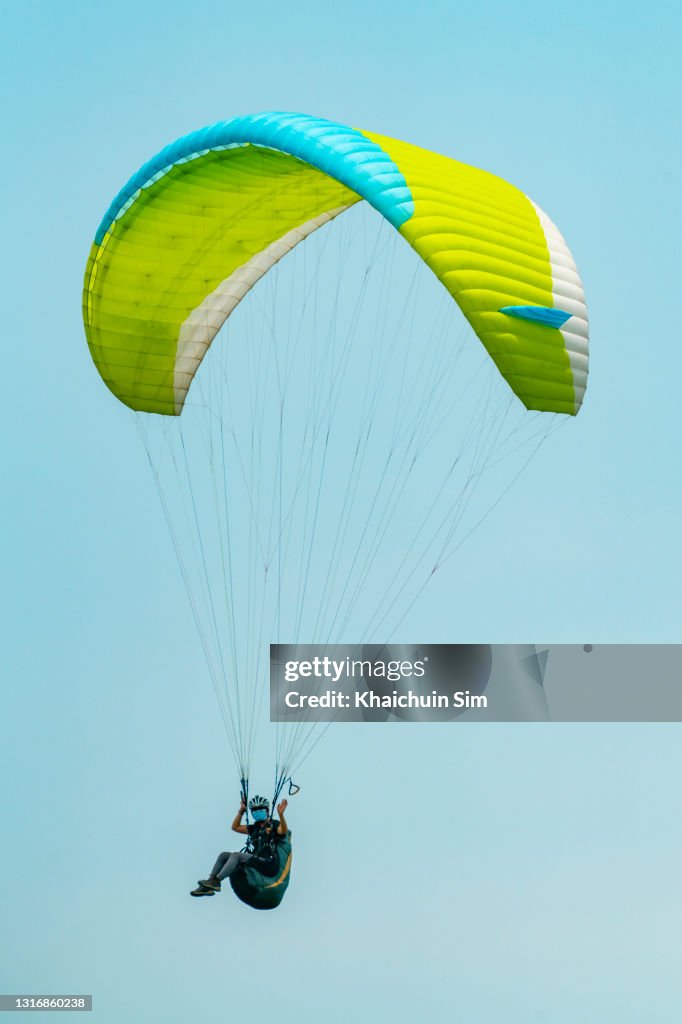 Paragliding in blue sky