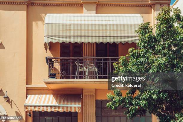 renovated apartment building with awning - window awnings bildbanksfoton och bilder