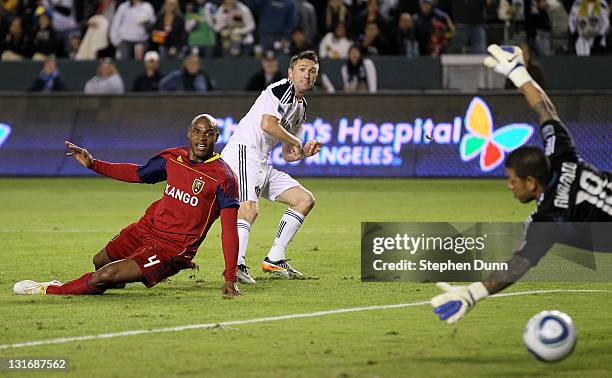 Robbie Keane of the Los Angeles Galaxy gets a shot past Jamison Olave and goal keeper Nick Rimando of Real Salt Lake to score the Galaxy's third goal...