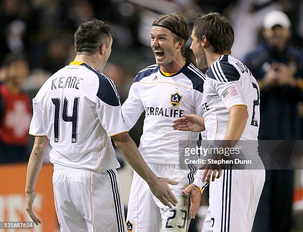 Robbie Keane of the Los Angeles Galaxy celebrates with David Beckham and Todd Dunivant after Keane scored the Galaxy's third goal against Real Salt...