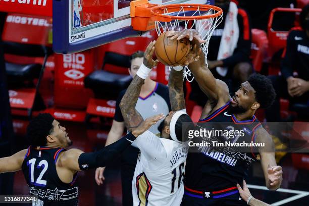 Joel Embiid of the Philadelphia 76ers blocks James Johnson of the New Orleans Pelicans during the fourth quarter at Wells Fargo Center on May 07,...