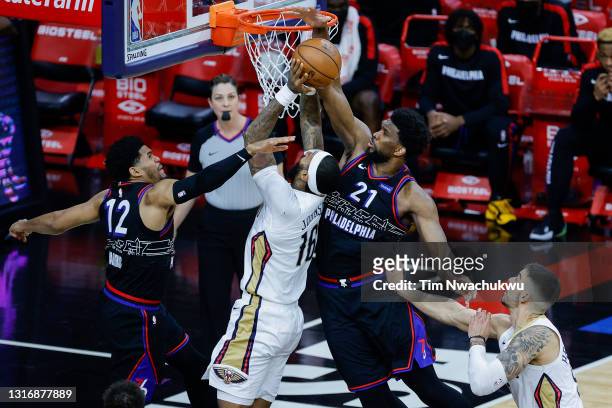 Joel Embiid and Tobias Harris of the Philadelphia 76ers defend the shot attempt by James Johnson of the New Orleans Pelicans during the fourth...