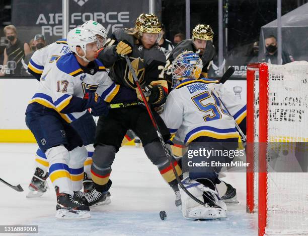 Jaden Schwartz of the St. Louis Blues pushes William Karlsson of the Vegas Golden Knights into Jordan Binnington of the Blues in the second period of...