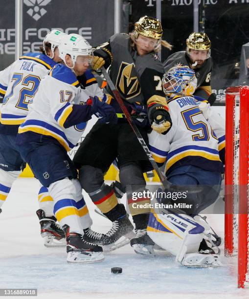 Jaden Schwartz of the St. Louis Blues pushes William Karlsson of the Vegas Golden Knights into Jordan Binnington of the Blues in the second period of...