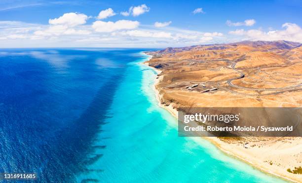 volcanic landscape along the coastline, fuerteventura, spain - fuerteventura stock-fotos und bilder