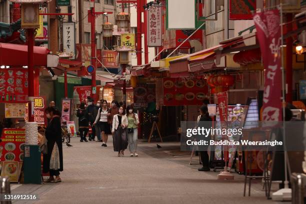 Tourist wearing protective face masks walk along Chinatown on May 08, 2021 in Kobe, Japan. Prime Minister Yoshihide Suga announced yesterday that the...