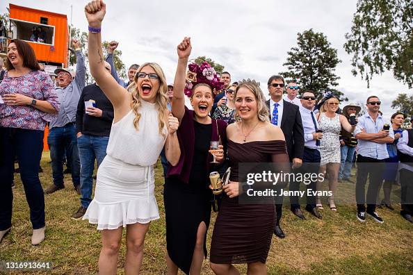Cobar Races Racegoers cheer during the Cobar Races at Cobar Miners' Race Club on ...
