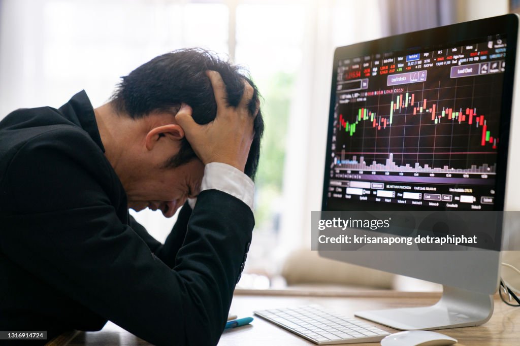 Stressed businessmen, stock market investors stressed, stock falls, stock market falls