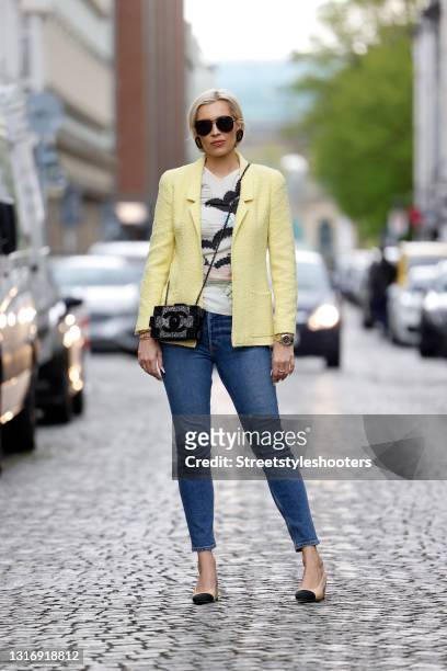 Radio presenter Verena Kerth, wearing a pastel yellow blazer by Chanel, a multicolored shirt by Chanel, blue denim jeans pants by Re/done, a black...