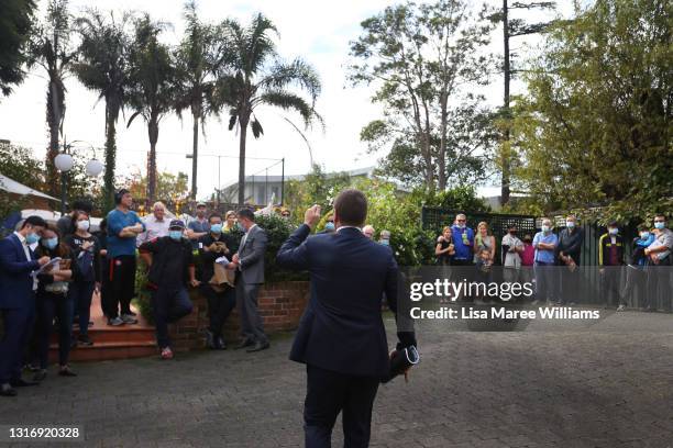 Auctioneer Jesse Davidson counts down a bid during an auction of a residential property in the suburb of Strathfield on May 08, 2021 in Sydney,...