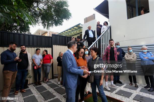 Prospective buyers attend an auction of a residential property in Hurlstone Park on May 08, 2021 in Sydney, Australia. Property prices continue to...