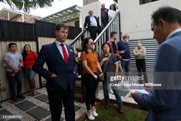 Prospective buyers attend an auction of a residential property in Hurlstone Park on May 08, 2021 in Sydney, Australia. Property prices continue to...