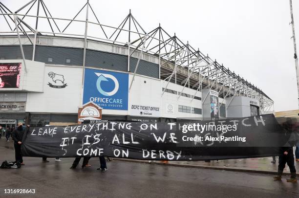 Derby fans hold a banner outside the stadium prior to the Sky Bet Championship match between Derby County and Sheffield Wednesday at Pride Park...