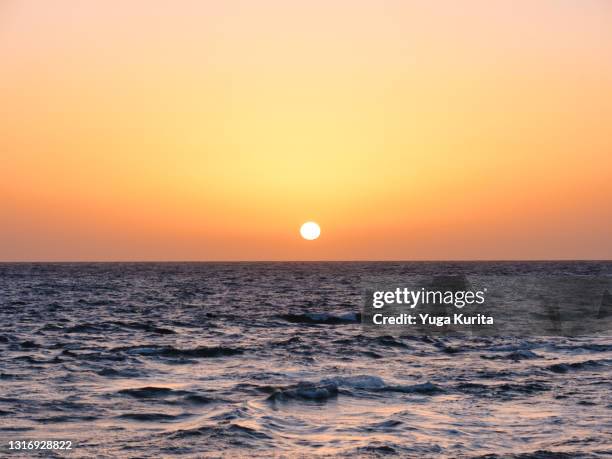 sunset/sunrise over the horizon - 日の出　海 ストックフォトと画像