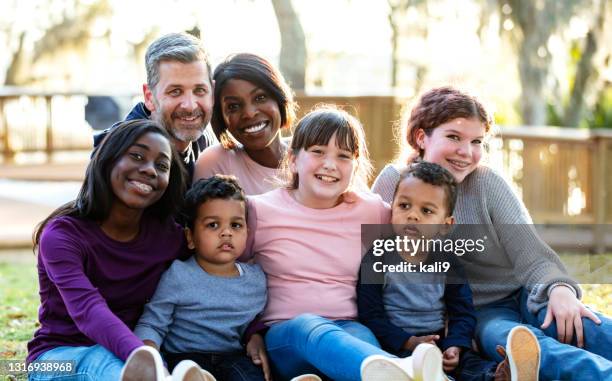 blended family with five children sitting in park - family with five children stock pictures, royalty-free photos & images