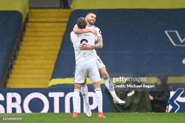 Stuart Dallas of Leeds United celebrates with Luke Ayling after scoring their side's first goal during the Premier League match between Leeds United...