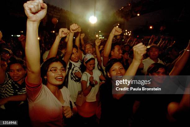 Filipinos cheer after Gloria Arroyo was sworn in as the Philippines'' new president January 20, 2001 at the EDSA shrine in Manila. Arroyo took over...