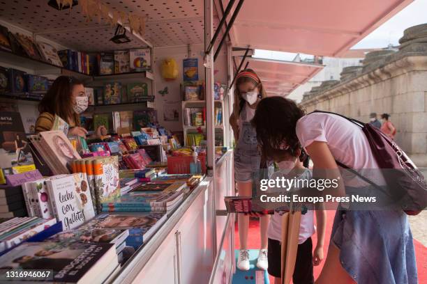 Woman and two children look through books at the Merida Book Fair, May 8 in Merida, Badajoz, Spain. Merida celebrates its 40th Book Fair from...