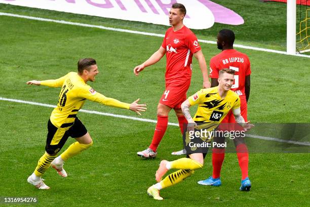 Marco Reus of Borussia Dortmund celebrates with Lukasz Piszczek after scoring their team's first goal during the Bundesliga match between Borussia...