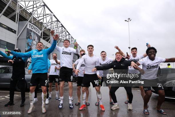 Players of Derby County celebrate their side's safety outside the ground after the Sky Bet Championship match between Derby County and Sheffield...