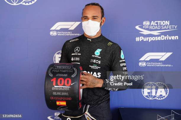 Pole position qualifier Lewis Hamilton of Great Britain and Mercedes GP celebrates with his pole position award in parc ferme after qualifying for...