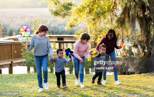blended family of five children walking in park together - half brother stock pictures, royalty-free photos & images