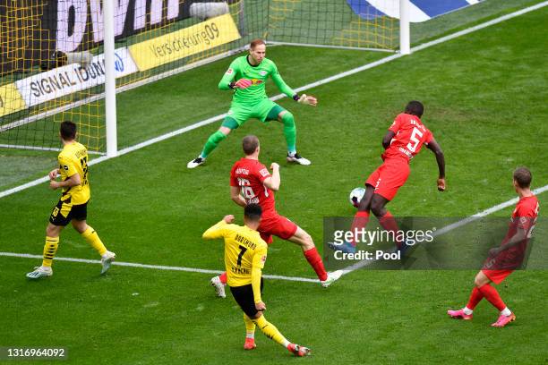 Jadon Sancho of Borussia Dortmund scores their side's second goal past Peter Gulacsi of RB Leipzig during the Bundesliga match between Borussia...